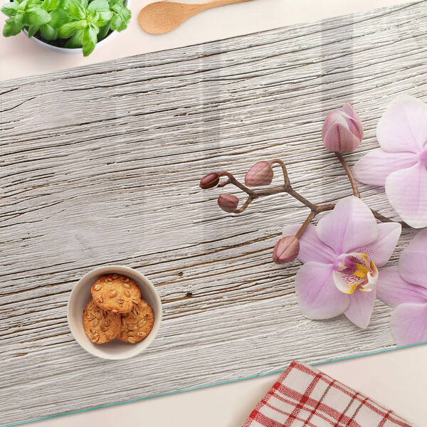 Skleněná deska do kuchyně Orchideje na dřevěném pozadí