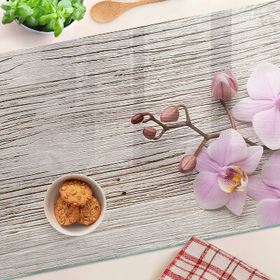 Skleněná deska do kuchyně Orchideje na dřevěném pozadí