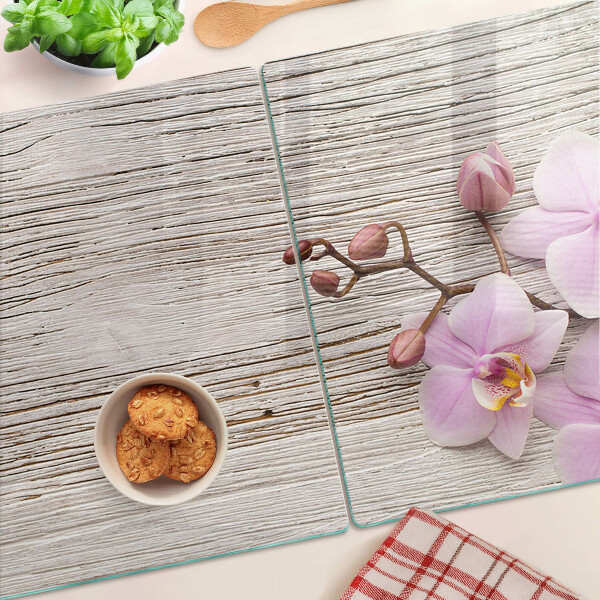 Skleněná deska do kuchyně Orchideje na dřevěném pozadí