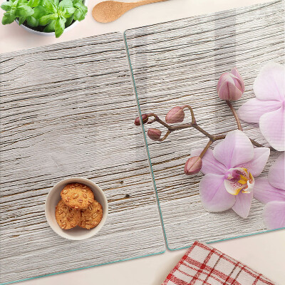 Skleněná deska do kuchyně Orchideje na dřevěném pozadí