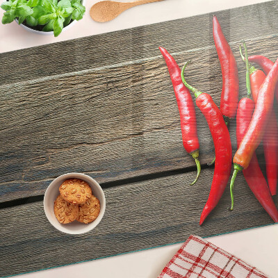 Skleněná deska do kuchyně Chilli papričky na dřevěném pozadí