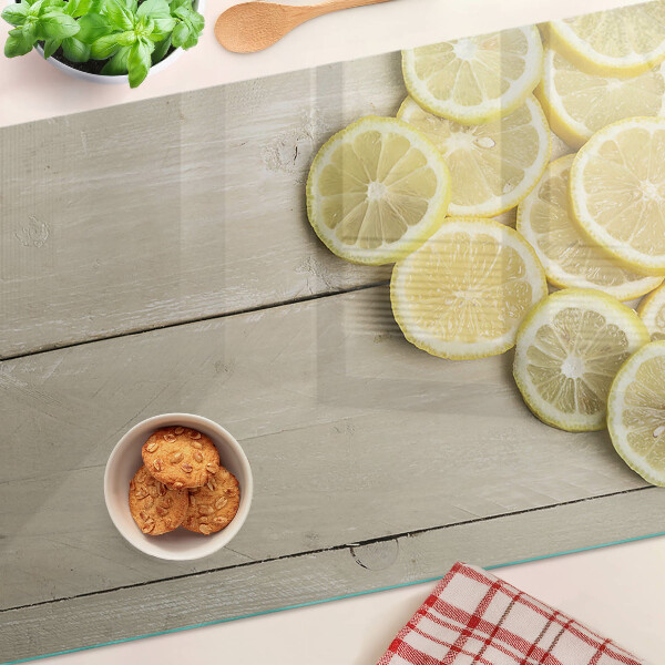 Skleněná deska do kuchyně Plátky citronu na dřevěném pozadí