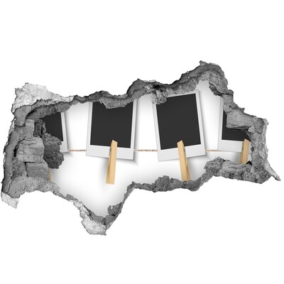 Foto fotografie díra na zeď Poškozená zeď s obrazovými rámy