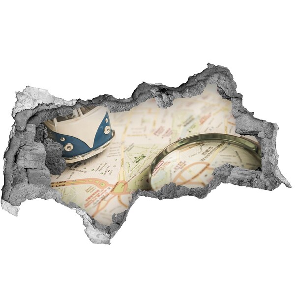 Samolepící díra na stěnu Mapa s lupou v díře ve zdi