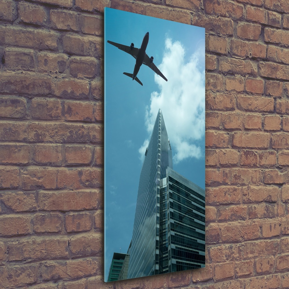 Foto obraz akrylový vertikální Letadlo nad městem