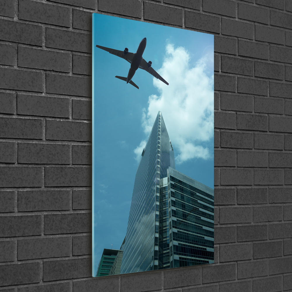 Vertikální Fotoobraz na skle Letadlo nad městem